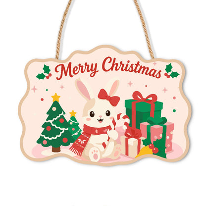 Snow Bunny with a Candy Cane paint by numbers hanging sign – White bunny with a red bow and scarf holding a candy cane by a tree and gifts on pink, with Merry Christmas, on a wooden sign with a rope hanger