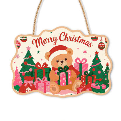 Santa Hat Teddy Among Pink Gifts paint by numbers hanging sign – Teddy bear in a Santa hat hugging a gift among pink and green trees and presents, with Merry Christmas, on a wooden sign with a rope hanger