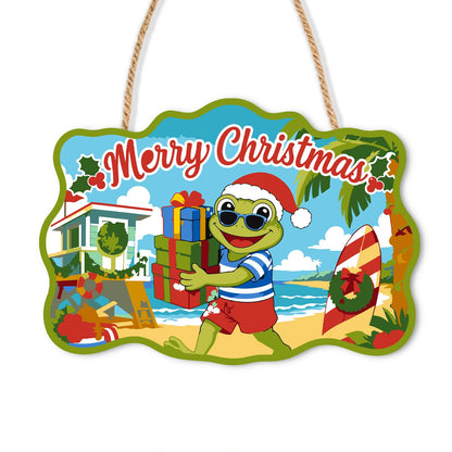 Beach Frog with Stacked Gifts paint by numbers hanging sign – Frog in a Santa hat and striped shirt carrying a stack of gifts on a beach by a beach house and surfboard, on a wooden sign with a rope hanger