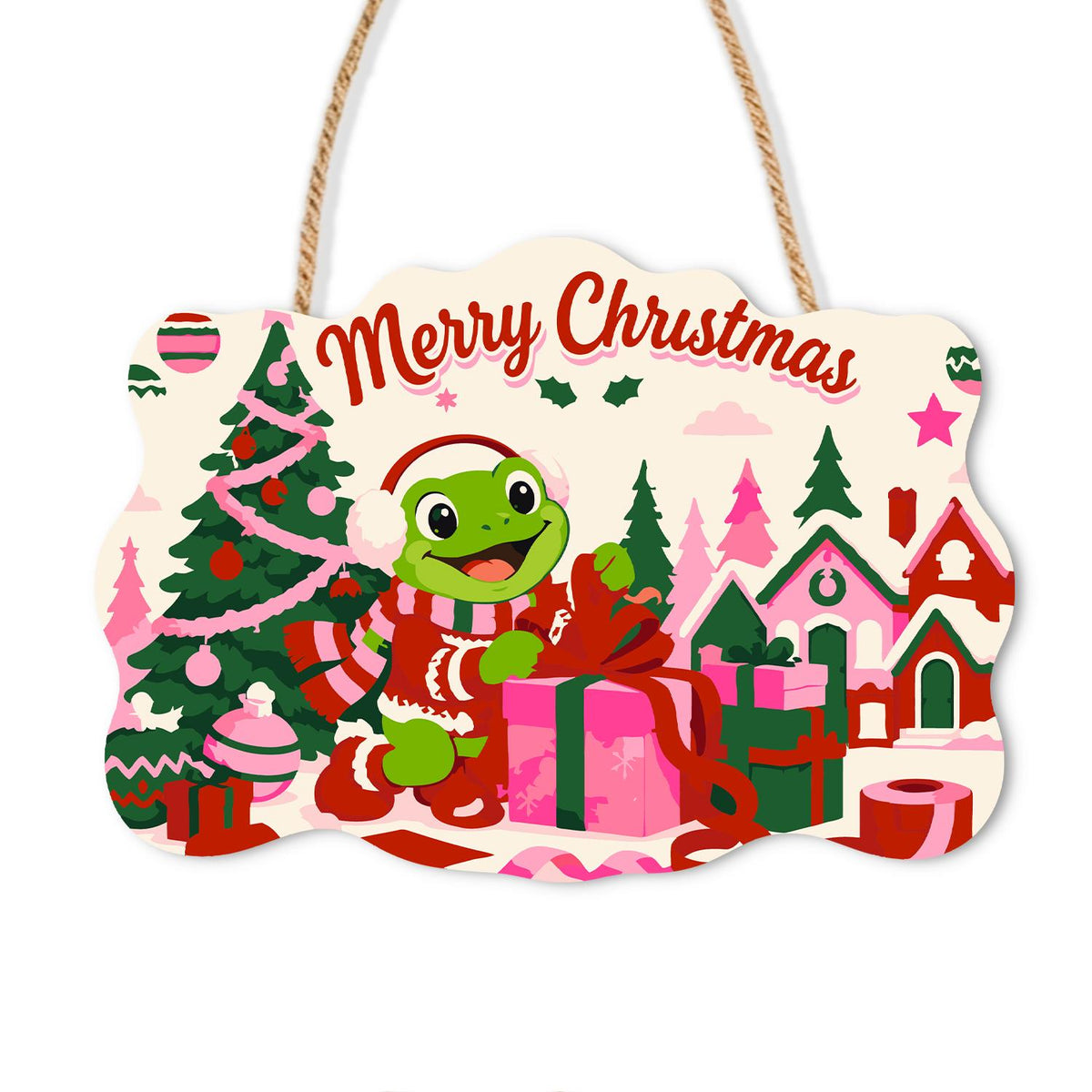 Gift-Wrapping Frog by the Tree paint by numbers hanging sign – Frog in a Santa hat and striped scarf wrapping gifts beside a Christmas tree in a pink village, on a wooden sign with a rope hanger