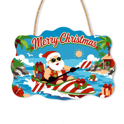 Candy-Striped Kayak Santa paint by numbers hanging sign – Santa in sunglasses paddling a red and white striped kayak loaded with gifts on a tropical sea, on a wooden sign with a rope hanger