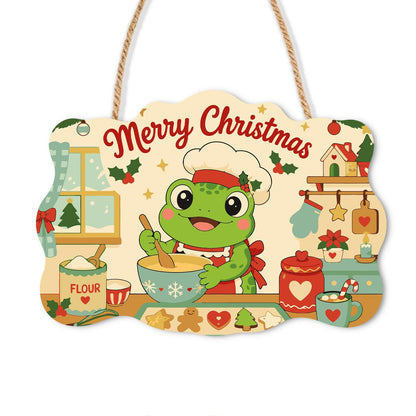 Baker Frog's Gingerbread Batch paint by numbers hanging sign – Green frog in a chef's hat stirring a mixing bowl beside a flour jar and gingerbread cookies, on a wooden sign with a rope hanger