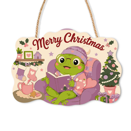 Bookworm Frog in Purple Armchair paint by numbers hanging sign – Frog in a pink beanie and glasses reading a book in a purple armchair beside a Christmas tree, on a wooden sign with a rope hanger