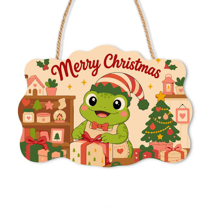 Elf Hat Frog with Bow Tie paint by numbers hanging sign – Frog in a striped elf hat and bow tie wrapping a gift beside shelves and a Christmas tree, on a wooden sign with a rope hanger