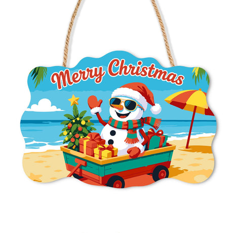 Snowman's Gift Wagon Beach Trip paint by numbers hanging sign – Waving snowman in a Santa hat and sunglasses riding a red wagon of gifts and a tree on the beach, on a wooden sign with a rope hanger