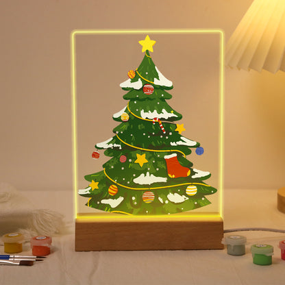 Snow-Dusted Tree with Gold Star paint by numbers light-up sign – Snow-dusted green Christmas tree with a gold star, garlands, baubles and a small stocking, lit up on its wooden base