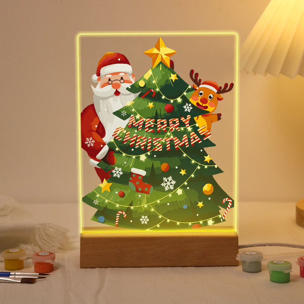 Peekaboo Santa Behind the Tree paint by numbers light-up sign – Santa and a reindeer peeking from behind a tall starry Christmas tree with lights and a Merry Christmas banner, lit up on its wooden base