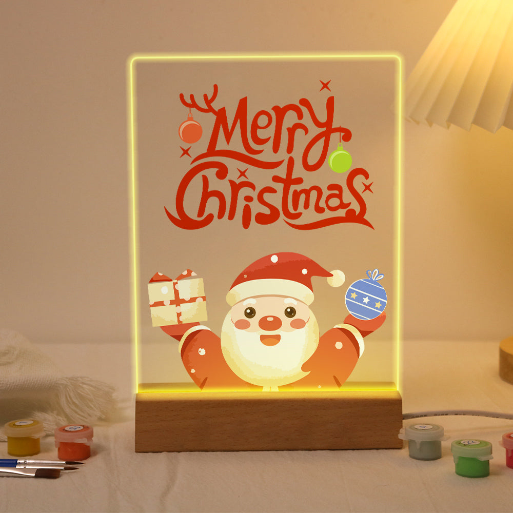 Santa Raising a Gift and Bauble paint by numbers light-up sign – Smiling Santa raising a wrapped gift and a blue bauble below large Merry Christmas script with antlers, lit up on its wooden base