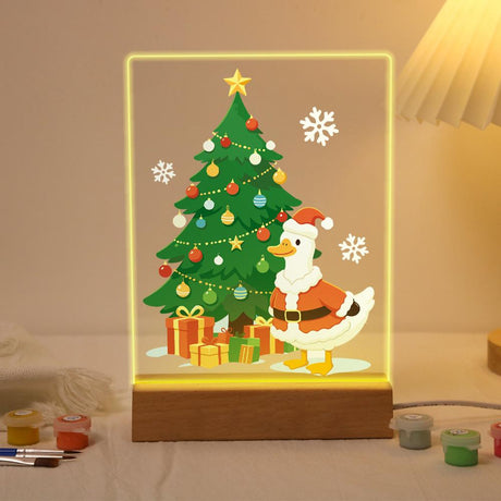 Santa Duck by the Towering Tree paint by numbers light-up sign – Tall decorated Christmas tree with a gold star and presents, a white duck in a Santa suit standing beside it, lit up on its wooden base