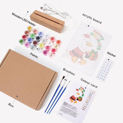 Duck Delivering a Holiday Gift paint by numbers light-up sign – what's in the kit: the acrylic sheet, wooden LED base, numbered paints and brushes