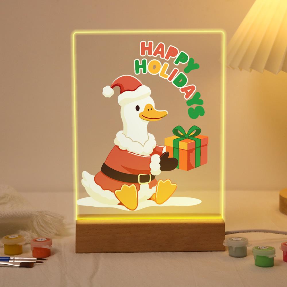 Duck Delivering a Holiday Gift paint by numbers light-up sign – White duck in a Santa suit and hat sitting with an orange gift box tied with green ribbon, Happy Holidays lettering, lit up on its wooden base