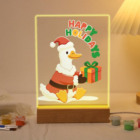 Duck Delivering a Holiday Gift paint by numbers light-up sign – White duck in a Santa suit and hat sitting with an orange gift box tied with green ribbon, Happy Holidays lettering, lit up on its wooden base