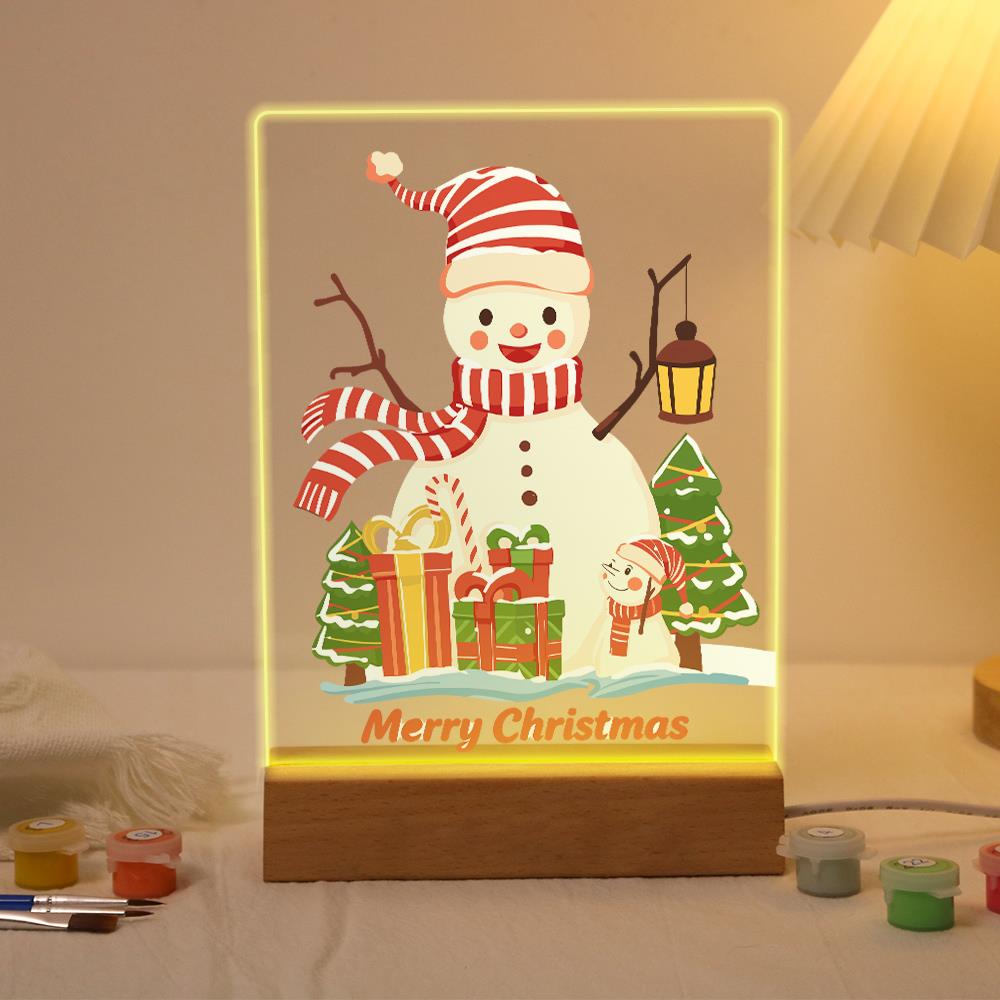 Striped-Hat Snowman with Lantern paint by numbers light-up sign – Snowman in a red striped hat and scarf holding a lantern beside gifts, small pine trees and a tiny snowman, lit up on its wooden base