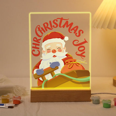 Jolly Santa at the Sleigh Reins paint by numbers light-up sign – Smiling Santa with rosy cheeks holding the reins of his sleigh with a sack of gifts, Christmas Joy lettering above, lit up on its wooden base