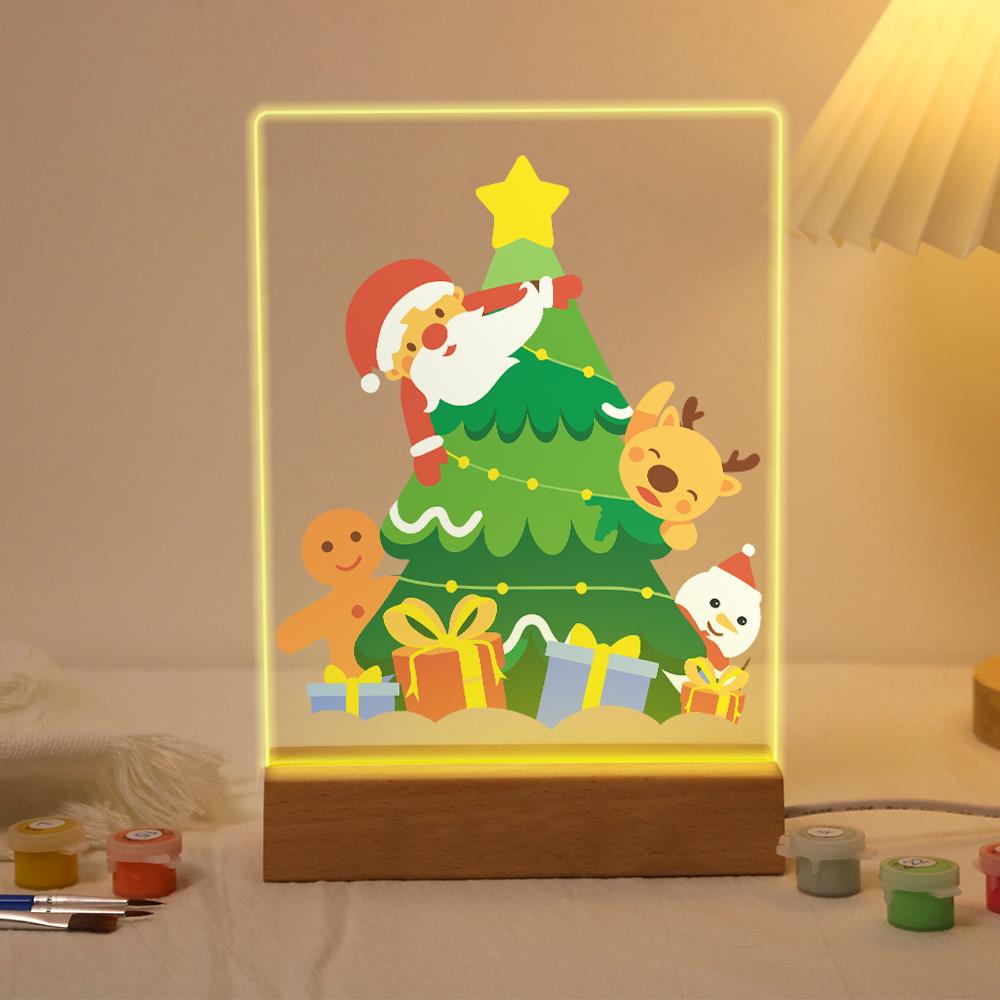 Santa Peeking From the Tree paint by numbers light-up sign – Santa peeking around a star-topped Christmas tree with a gingerbread man, reindeer, little snowman and gifts, lit up on its wooden base