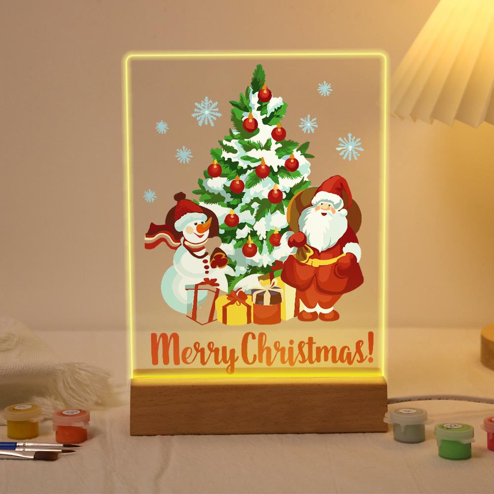 Snowy Pine with Santa and Snowman paint by numbers light-up sign – Snow-dusted Christmas tree with red baubles, a snowman on one side and Santa on the other, Merry Christmas lettering, lit up on its wooden base