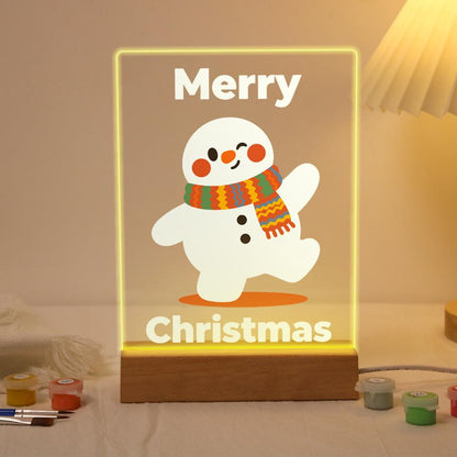Strolling Snowman in a Knit Scarf paint by numbers light-up sign – Smiling snowman in a striped orange and green knit scarf striding along with one arm raised, Merry Christmas lettering, lit up on its wooden base