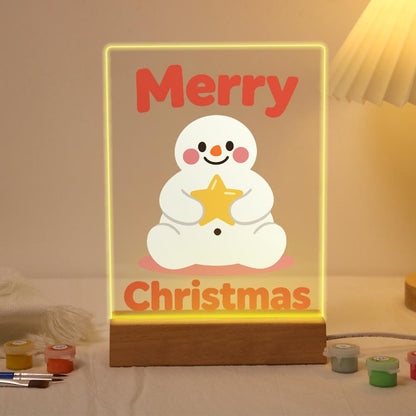 Snowman Hugging a Gold Star paint by numbers light-up sign – Chubby rosy-cheeked snowman sitting and hugging a gold star, with big red Merry Christmas lettering, lit up on its wooden base
