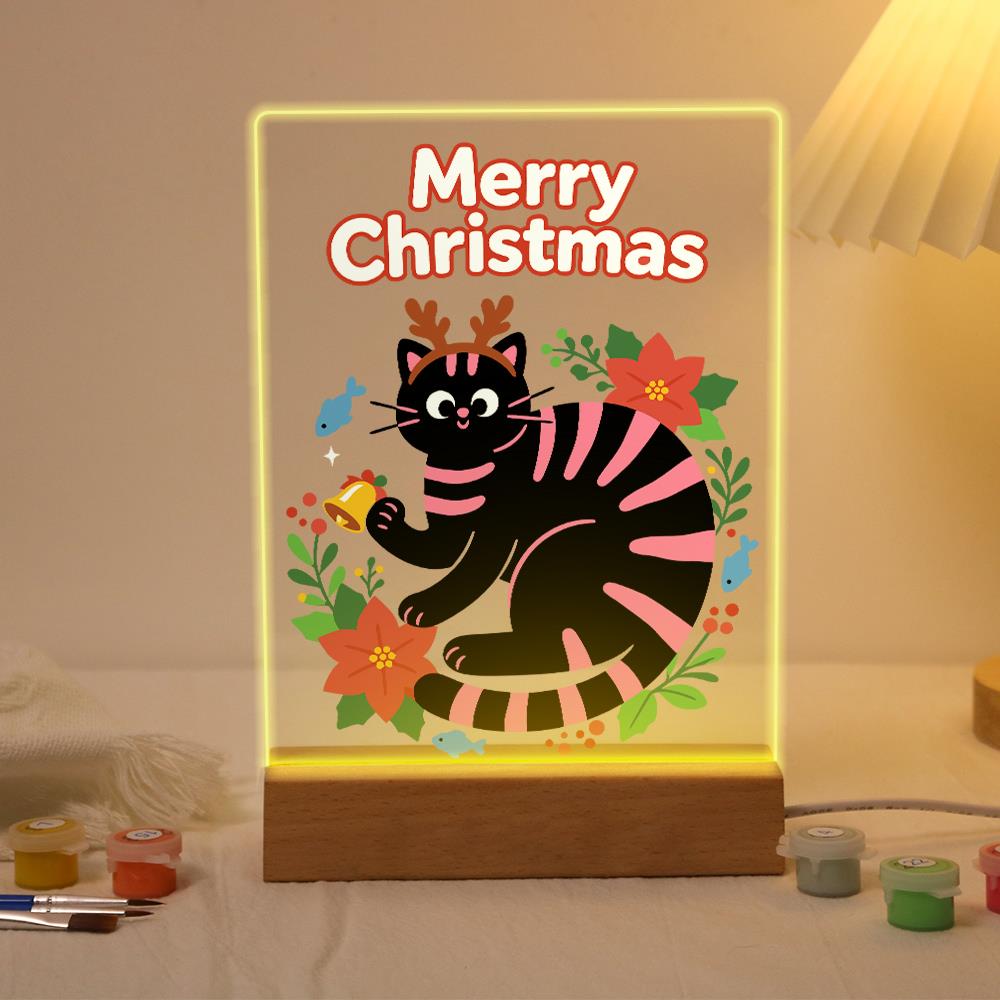 Antlered Black Cat in Poinsettias paint by numbers light-up sign – Black cat with pink stripes and reindeer antlers holding a bell inside a ring of poinsettias and holly, lit up on its wooden base