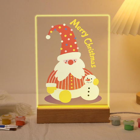 Tall-Hat Santa and Tiny Snowman paint by numbers light-up sign – Bearded Santa in a tall red polka-dot hat and striped coat sitting beside a small snowman, Merry Christmas lettering, lit up on its wooden base