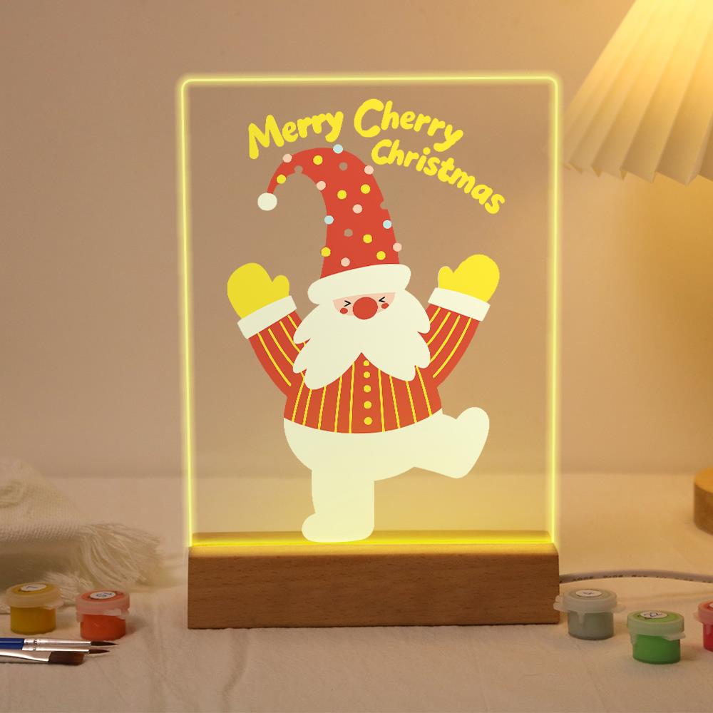 Santa Jumping for Joy paint by numbers light-up sign – Santa in a polka-dot hat leaping with both mittened arms raised below Merry Cherry Christmas lettering, lit up on its wooden base