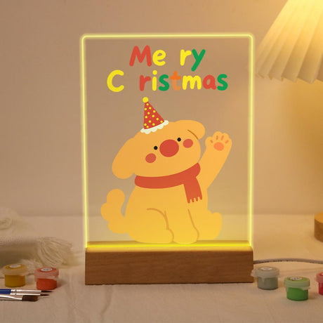 Waving Puppy in a Red Scarf paint by numbers light-up sign – Golden puppy in a red party hat and scarf waving a paw below colorful Merry Christmas letters, lit up on its wooden base