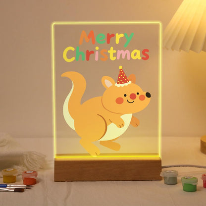 Hopping Holiday Kangaroo paint by numbers light-up sign – Smiling kangaroo in a red polka-dot party hat hopping below colorful Merry Christmas letters, lit up on its wooden base