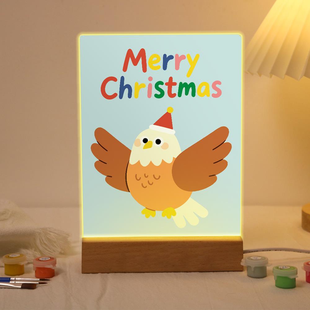 Eagle Spreading Festive Wings paint by numbers light-up sign – Brown eagle with a white head in a Santa hat spreading its wings on a pale blue background, lit up on its wooden base