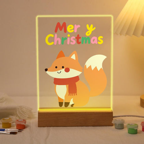 Cozy Fox in a Red Scarf paint by numbers light-up sign – Smiling orange fox in a red scarf sitting with its fluffy tail raised below Merry Christmas letters, lit up on its wooden base