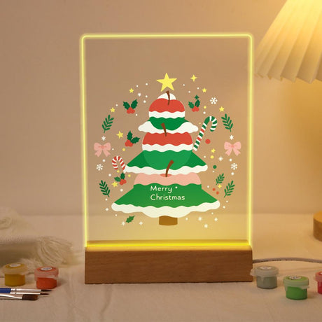 Frosted Tree in a Holly Ring paint by numbers light-up sign – Snow-frosted Christmas tree with red baubles and a gold star circled by holly, candy canes and pink bows, lit up on its wooden base