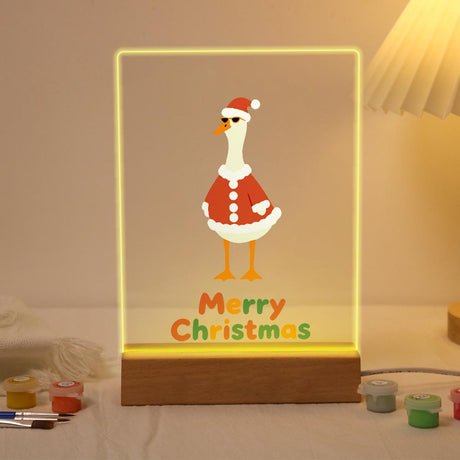 Tall Goose in a Santa Suit paint by numbers light-up sign – White long-necked goose in a red Santa coat and hat standing above Merry Christmas lettering, lit up on its wooden base
