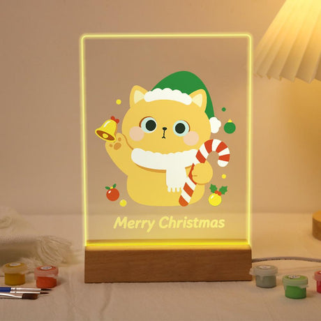 Elf Hat Cat Ringing a Bell paint by numbers light-up sign – Yellow cat in a green elf hat and white scarf ringing a gold bell and holding a candy cane, lit up on its wooden base