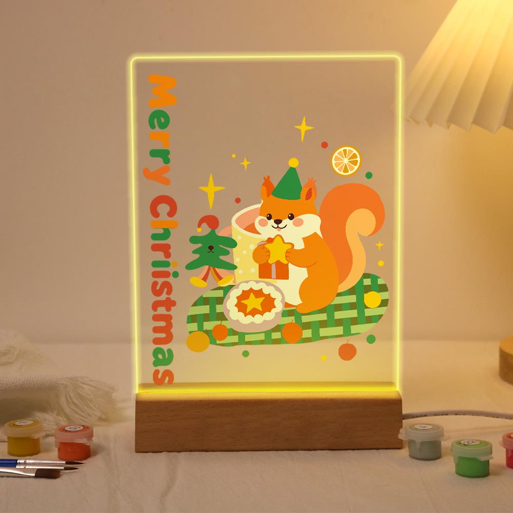 Elf Hat Squirrel with a Star paint by numbers light-up sign – Orange squirrel in a green elf hat holding a star beside a pie on a green plaid blanket, lit up on its wooden base