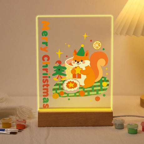 Elf Hat Squirrel with a Star paint by numbers light-up sign – Orange squirrel in a green elf hat holding a star beside a pie on a green plaid blanket, lit up on its wooden base