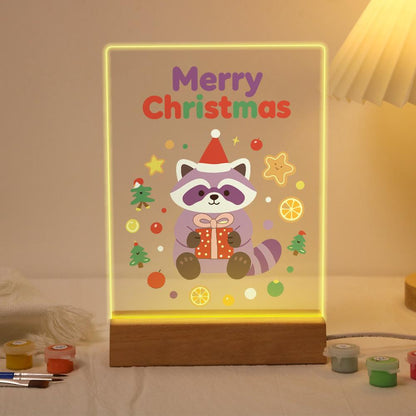Raccoon with a Gift and Cookies paint by numbers light-up sign – Lilac raccoon in a Santa hat holding a gift among gingerbread, orange slices and tiny trees, lit up on its wooden base