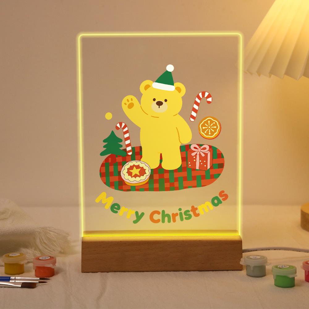 Elf Hat Bear's Holiday Picnic paint by numbers light-up sign – Yellow bear in a green elf hat waving on a red plaid blanket with a pie, a gift and candy canes, lit up on its wooden base