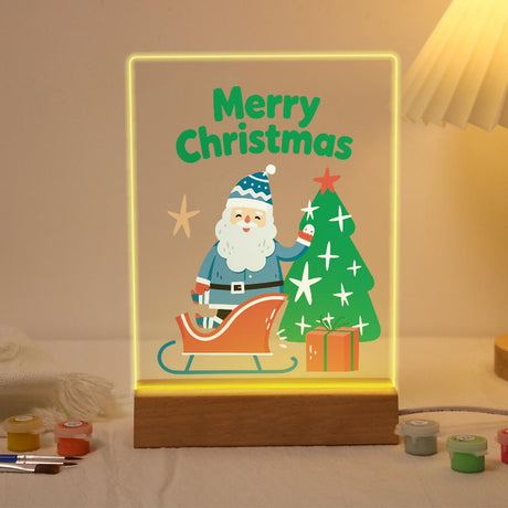 Blue-Coat Santa by His Sleigh paint by numbers light-up sign – Santa in a blue coat and knit hat standing by a sleigh, a starry Christmas tree and a gift, lit up on its wooden base