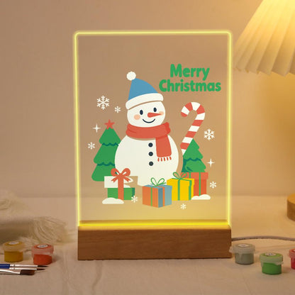 Snowman with a Candy Cane Staff paint by numbers light-up sign – Snowman in a blue hat and red scarf holding a candy cane beside pine trees and wrapped gifts, lit up on its wooden base
