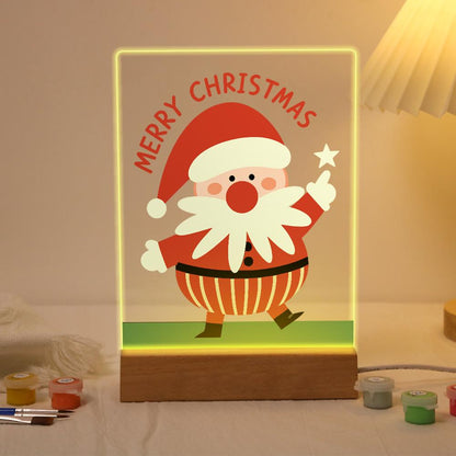Santa Pointing to a Star paint by numbers light-up sign – Santa strolling on green grass and pointing up at a white star below arched Merry Christmas lettering, lit up on its wooden base
