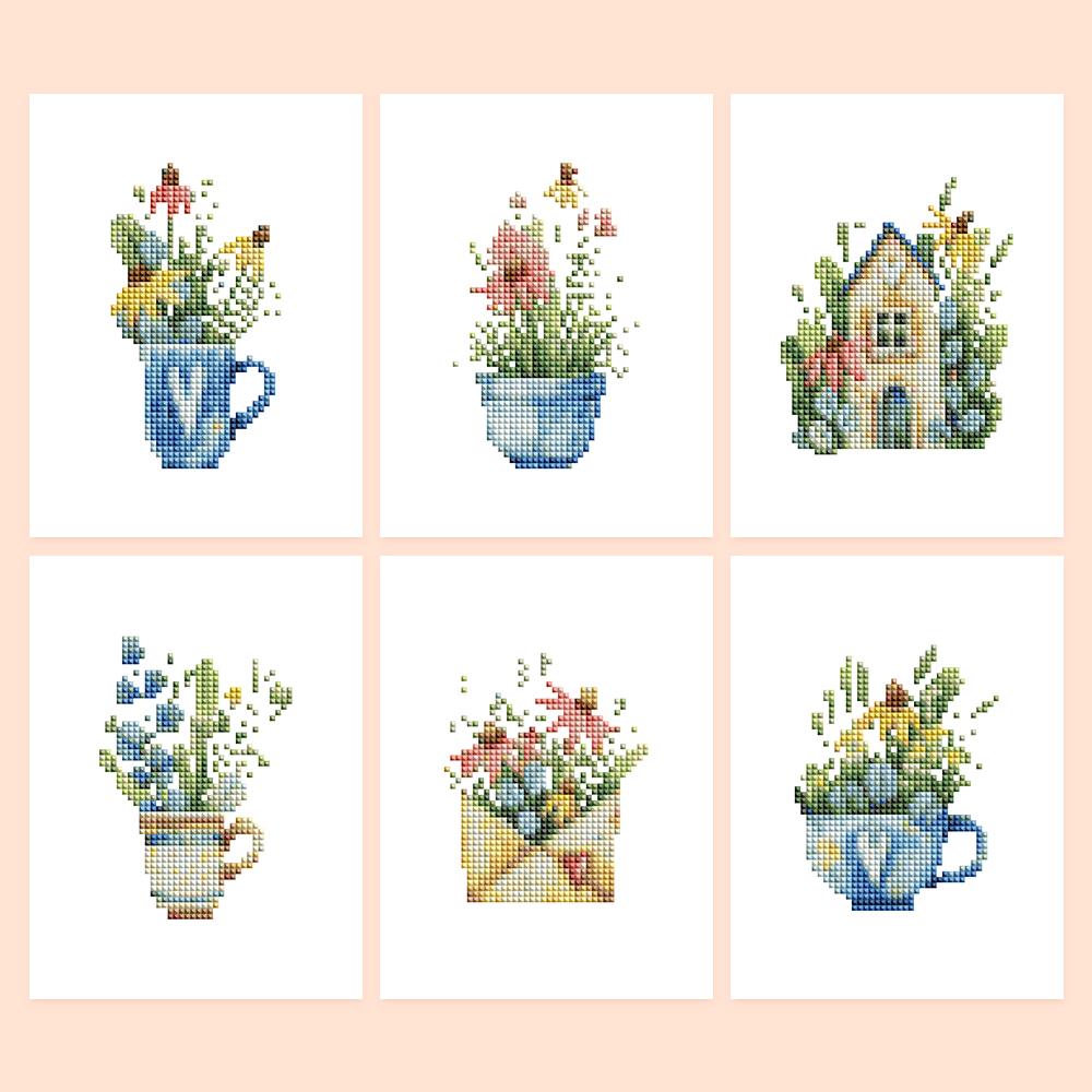 Wildflowers in Teacups mini diamond painting – Wildflowers spilling from blue teacups and a mug, an envelope full of blooms and a flower-covered cottage