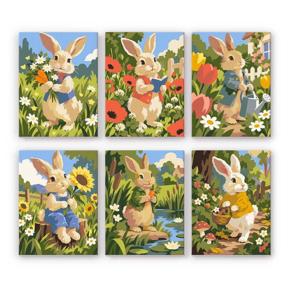 Waistcoat Bunnies in Poppies mini paint by numbers – Six rabbits in waistcoats among poppies, tulips and sunflowers, with a watering can, a pond and a basket
