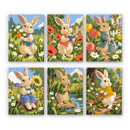 Waistcoat Bunnies in Poppies mini paint by numbers – Six rabbits in waistcoats among poppies, tulips and sunflowers, with a watering can, a pond and a basket