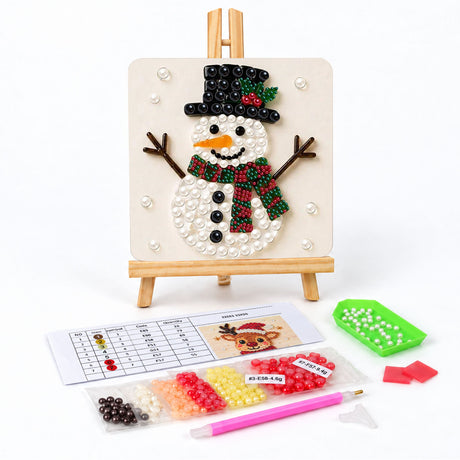 Snowman with a Holly Top Hat pearl painting easel kit – Snowman with a black top hat trimmed with holly, a striped green scarf, stick arms and a carrot nose