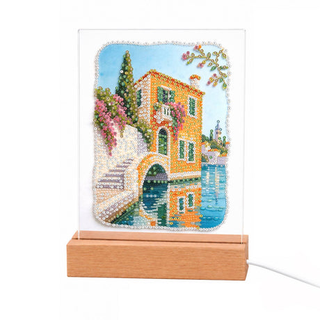 Canal-Side Villa and Stone Bridge light-up pearl painting – Peach-colored canal house with flower-draped balconies beside an arched stone bridge over blue water
