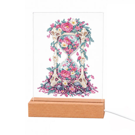 Hourglass Filled with Pink Blooms light-up pearl painting – Ornate pale hourglass filled and crowned with pink roses and blossoms, petals spilling at its base
