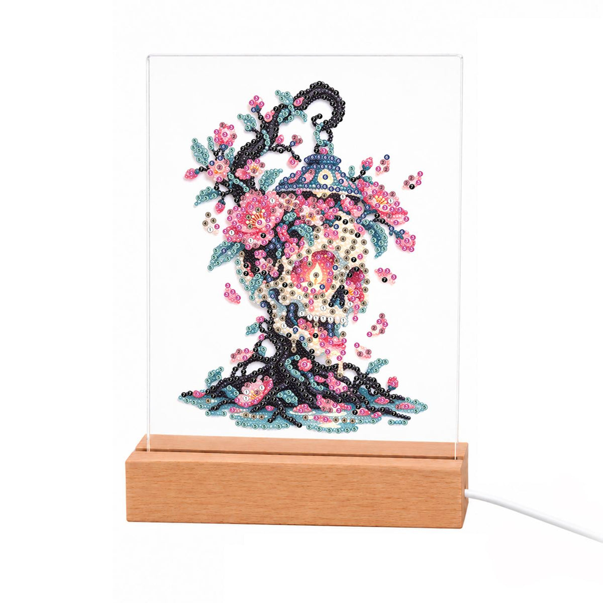Blossom Skull on Twisted Roots light-up pearl painting – Skull shaped from pink blossoms and teal leaves above dark twisted roots, with a hanging lantern