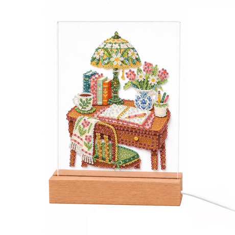 Stained-Glass Lamp Writing Desk light-up pearl painting – Wooden writing desk with a stained-glass lamp, books, a teacup, pink flowers and a green chair