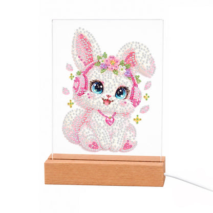 Flower-Crowned Bunny in Headphones light-up pearl painting – Pink-and-white bunny in pink headphones and a flower crown with a heart pendant and big blue eyes