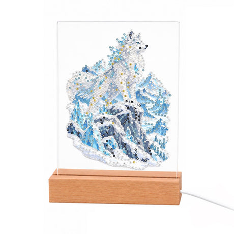 Snow Wolf on Icy Blue Peaks light-up pearl painting – White wolf peering over icy blue snow-covered mountain peaks