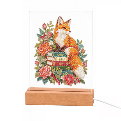Fox Atop a Stack of Books light-up pearl painting – Orange fox resting on a stack of books surrounded by coral and pink peonies and roses